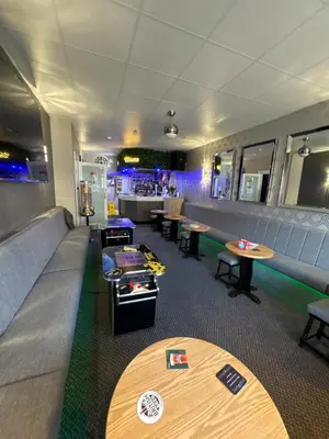 a restaurant with tables and chairs and a bar at Clifton Private Hotel in Blackpool