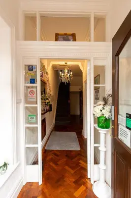 a hallway of a home with a chandelier at The Carlton in Blackpool