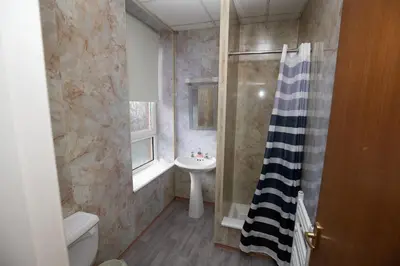 a bathroom with a sink and a toilet and a shower at The Carlton in Blackpool