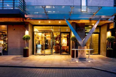 a store front with a large letter v in front of it at The Vincent Hotel in Southport