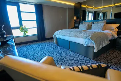 a hotel room with a bed and a couch at The Vincent Hotel in Southport