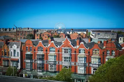 a large red brick building with white windows at The Vincent Hotel in Southport