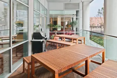 a balcony with benches and tables on a building at Staybridge Suites Liverpool by IHG in Liverpool