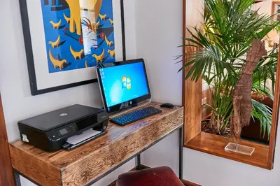 a desk with a computer and a printer on it at Staybridge Suites Liverpool by IHG in Liverpool
