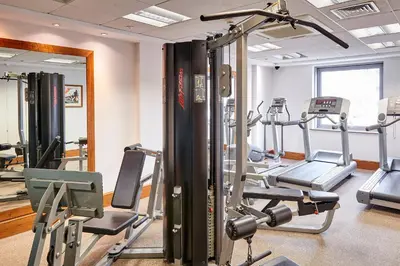 a gym with several tread machines in a room at Staybridge Suites Liverpool by IHG in Liverpool