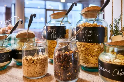 a table topped with jars of different types of food at Staybridge Suites Liverpool by IHG in Liverpool