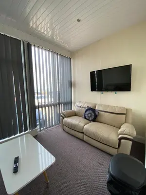 a living room with a couch and a flat screen tv at South Beach Hotel in Blackpool