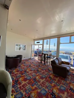 a living room with a couch and chairs and a table at South Beach Hotel in Blackpool