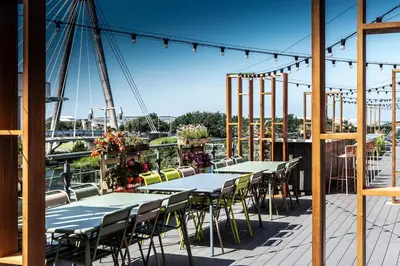 a row of tables and chairs on a patio at Waterfront Southport Hotel in Southport