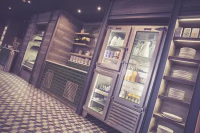 a kitchen with an open refrigerator with dishes at Waterfront Southport Hotel in Southport