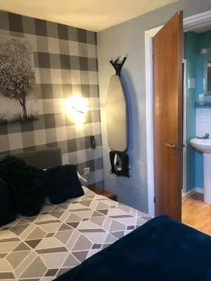 a bedroom with a bed with a surfboard on the wall at Springfield Hotel in Blackpool