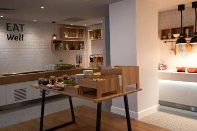 a kitchen with a table with food on it at Holiday Inn Preston by IHG in Preston