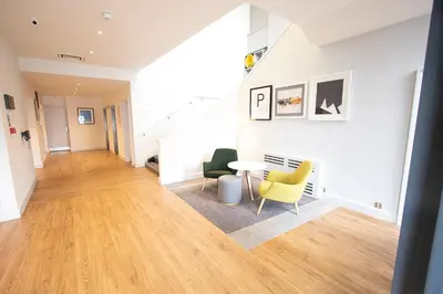 a living room with a table and chairs at Holiday Inn Preston by IHG in Preston