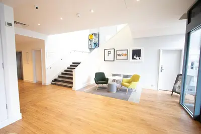 a living room with two chairs and a staircase at Holiday Inn Preston by IHG in Preston