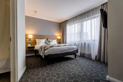a hotel room with a bed and a window at Holiday Inn Preston by IHG in Preston