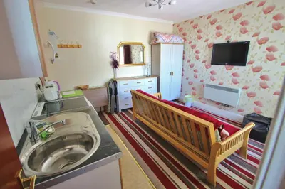 a small bathroom with a sink and a mirror at Fairhaven Holiday Flats in Blackpool