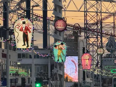 a group of signs hanging from a building with lights at Fairhaven Holiday Flats in Blackpool