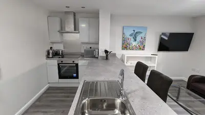 a kitchen with a sink and a counter top at Cocoon @ International Inn + Apartments in Liverpool