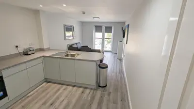 a kitchen with a sink and a counter top at Cocoon @ International Inn + Apartments in Liverpool