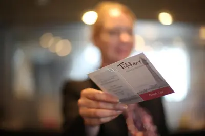 a man is holding a magazine in his hand at Tiffany's Hotel in Blackpool