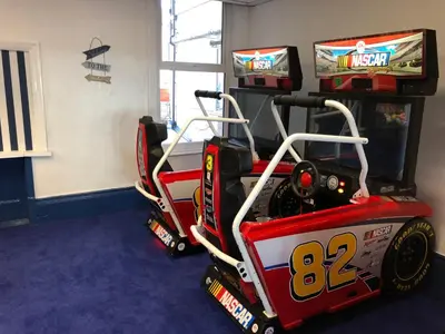 a red race car playing video games in a room at Tiffany's Hotel in Blackpool