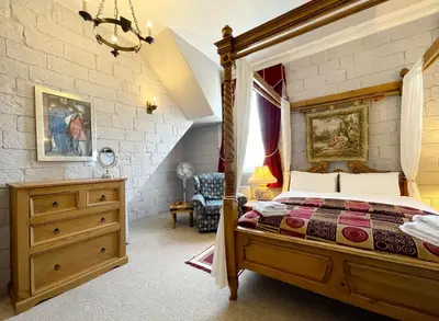 a bedroom with a bed and a dresser in it at Dukes Folly Hotel in Southport