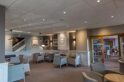 a waiting room with chairs and tables in a hospital at St Ives Hotel in Lytham St Annes