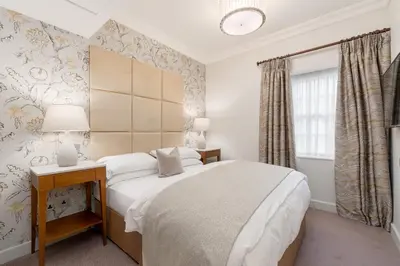 a bedroom with a bed and a desk and a window at Spa Hotel at Ribby Hall Village in Wrea Green