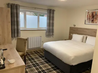 a bedroom with a bed and a window at The Claremont Preston in Preston