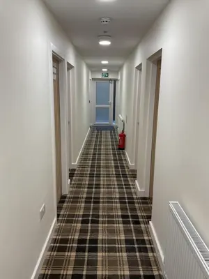 a hallway with a tile floor in a building at The Claremont Preston in Preston