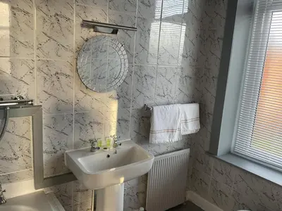 a white bathroom with a sink and a mirror at The Claremont Preston in Preston