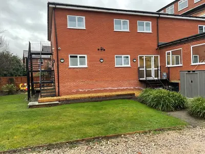 a brick house with a lawn in front of it at The Claremont Preston in Preston