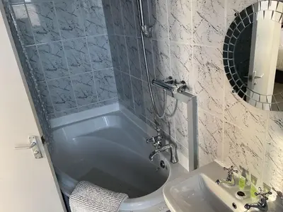 a bathroom with a tub and a sink at The Claremont Preston in Preston