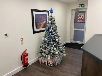 a christmas tree in the corner of a room at The Claremont Preston in Preston