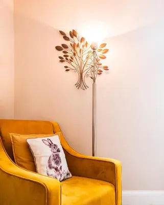 a yellow chair with a pillow and a lamp at Kelvin House in Fleetwood