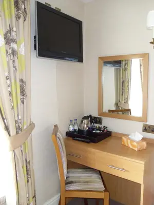 a room with a desk with a tv and a mirror at Wagon & Horses in Lancaster