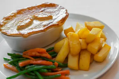 a plate of food with a bowl of dip and vegetables at Wagon & Horses in Lancaster