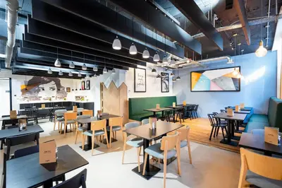 a restaurant with tables and chairs and a cafeteria at Staycity Aparthotels Liverpool Waterfront in Liverpool