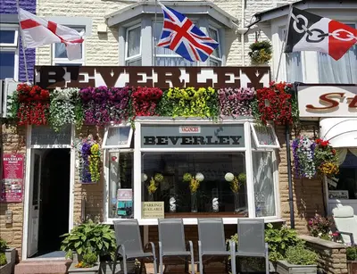 a store with flowers and flags in front of it at The Beverley Hotel in Blackpool