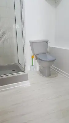 a white bathroom with a toilet and a shower at The Beverley Hotel in Blackpool