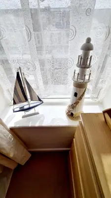 a room with a lighthouse and books on a window at The Beverley Hotel in Blackpool