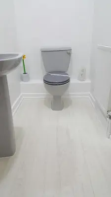 a white bathroom with a toilet and a sink at The Beverley Hotel in Blackpool