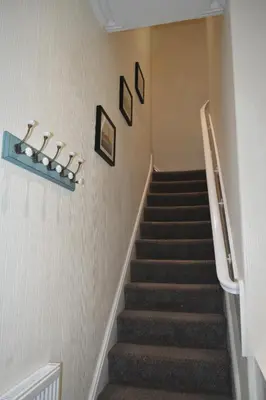 a staircase in a house with a stair case at Adelaide Apartments 2 in Blackpool