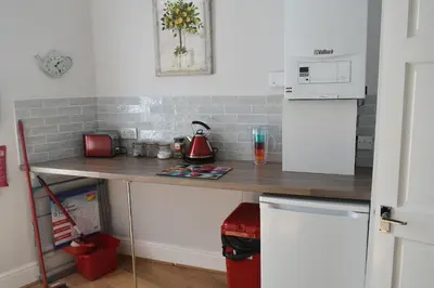 a kitchen with a counter top and a refrigerator at Adelaide Apartments 2 in Blackpool
