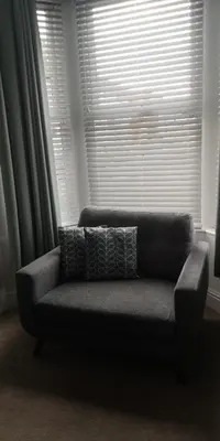 a couch in a living room with a window at 39 Cowley Road in Liverpool