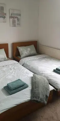 two beds sitting next to each other in a bedroom at 39 Cowley Road in Liverpool