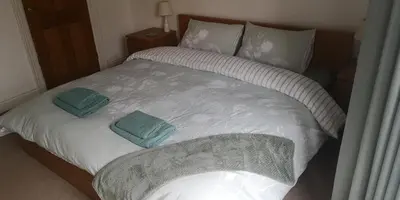 a bed with two pillows on top of it at 39 Cowley Road in Liverpool