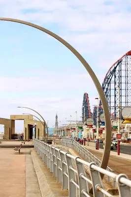 a metal arch over a boardwalk with a roller coaster at Sandpiper Holiday Apartments in Blackpool