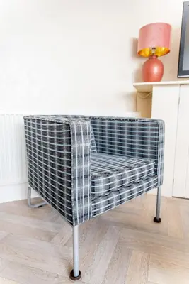 a chair with a blanket on it in a room at Sandpiper Holiday Apartments in Blackpool