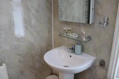a bathroom with a sink and a mirror at Mardonia Hotel in Blackpool
